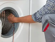 Dryer repair technician diagnosing and servicing a clothes dryer in Chicago, IL
