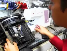 Vacuum repair technician servicing internal components on a workbench in Chicago, IL