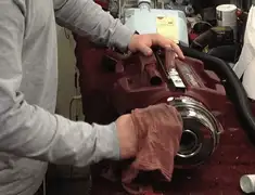 Vacuum repair technician cleaning and servicing a vacuum motor in Chicago, IL