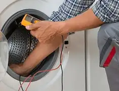 Washing machine repair technician testing a front-load washer with diagnostic tools in Chicago, IL